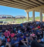 Eagle Pass, Texas crowd of migrants under bridge