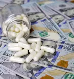 medicine and hundred dollar bills money, healthcare cost