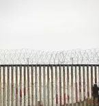 Illegal immigrant crossing border fence