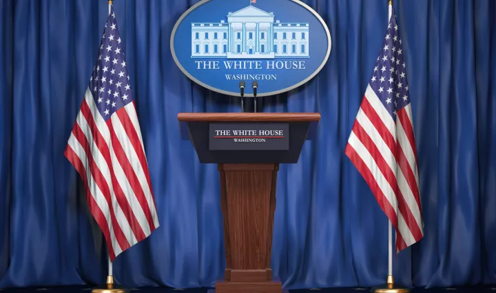 White House podium with two flags