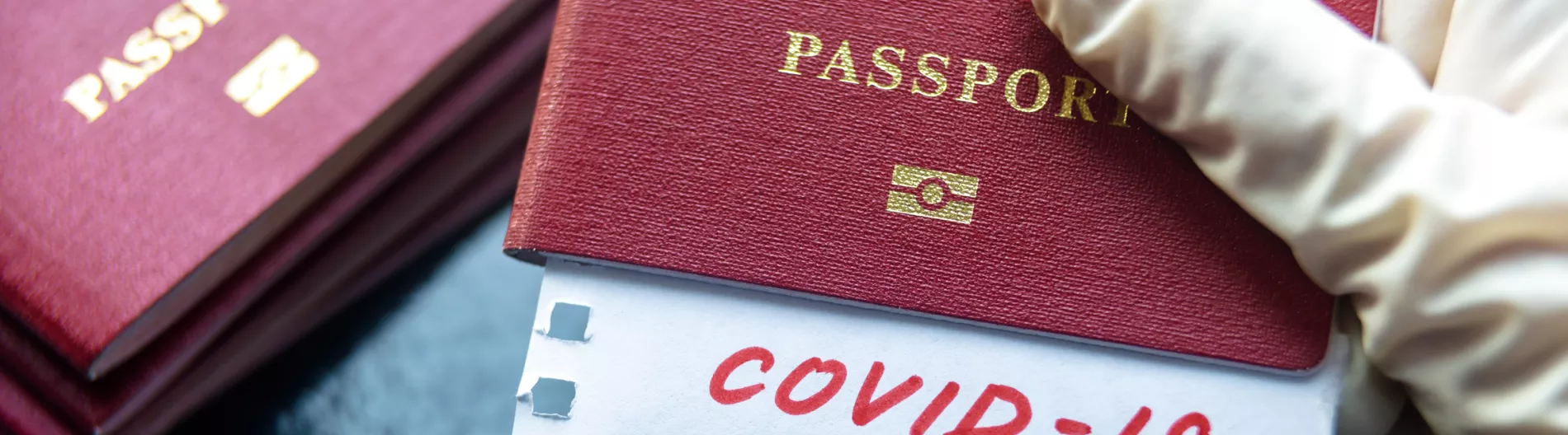 Passports and paper with COVID-19 written in red.