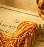 Gold tassel on a check written for college tuition