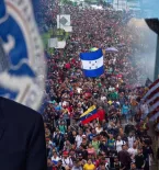 Biden Smiling, Migrant Thanking Him For TPS, Large Caravan waving flags of various countries