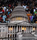 large caravan of migrants as background to U.S. capitol