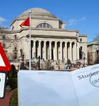 Columbia University building with Fraud Alert sign and a status granted student visa