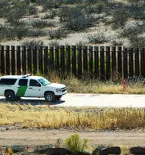 Border security truck at the border wall