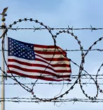 US Flag behind barbed wire