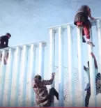 People going over the border wall