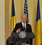 President Biden at podium with flags in background