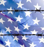 U.S. flag behind barbed wires