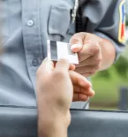 Driver handing officer driver's license
