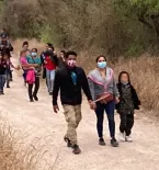 Group of migrants walking to the border
