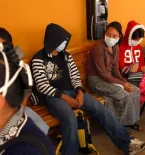 Group of detained people wearing masks