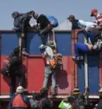 People climbing over the border wall