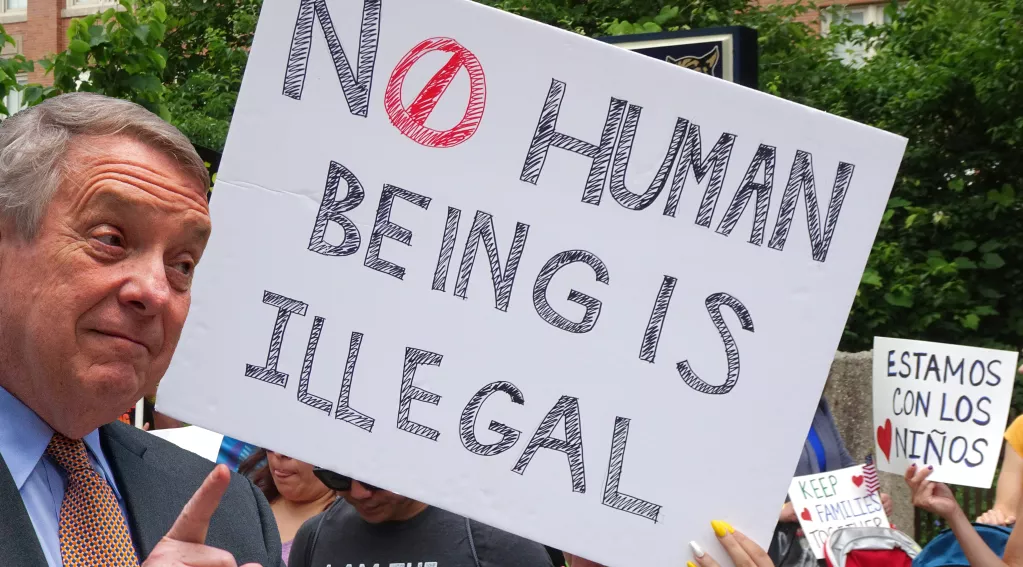 Dick Durban, No Human Being Is Illegal sign