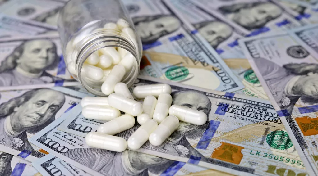 medicine and hundred dollar bills money, healthcare cost