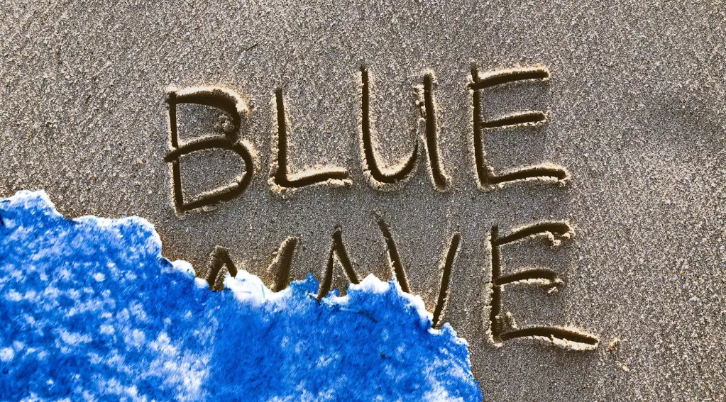 Blue wave written on sand