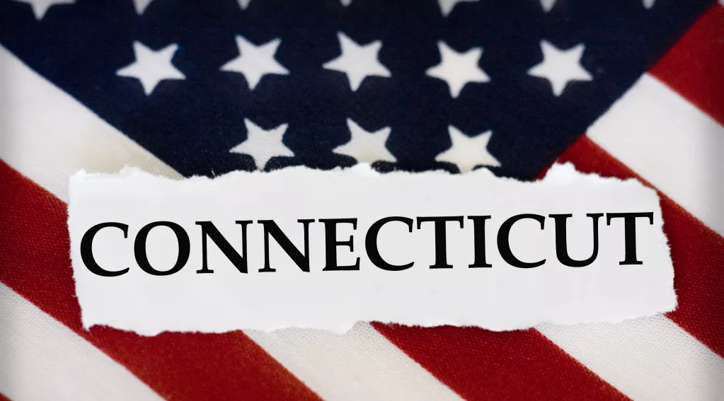 The word Connecticut with American flag background