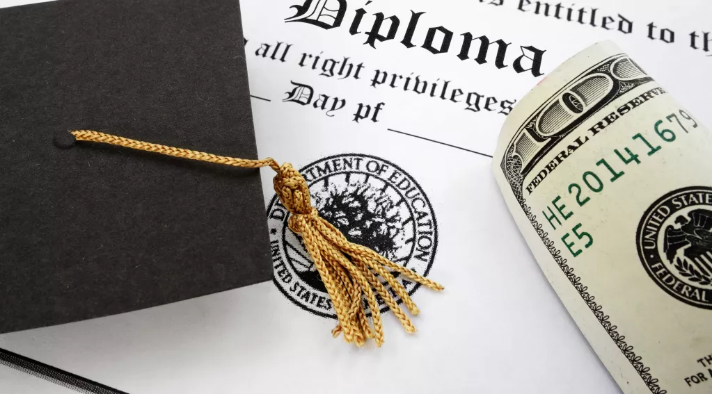Graduation cap, diploma and cash