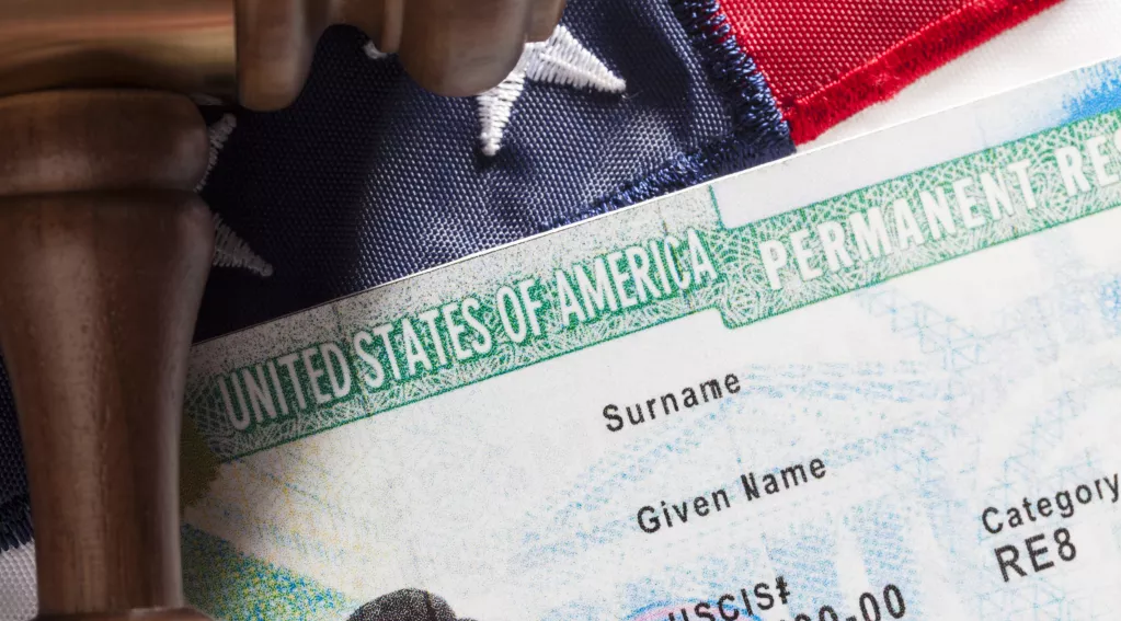 Image of green card, American flag and gavel