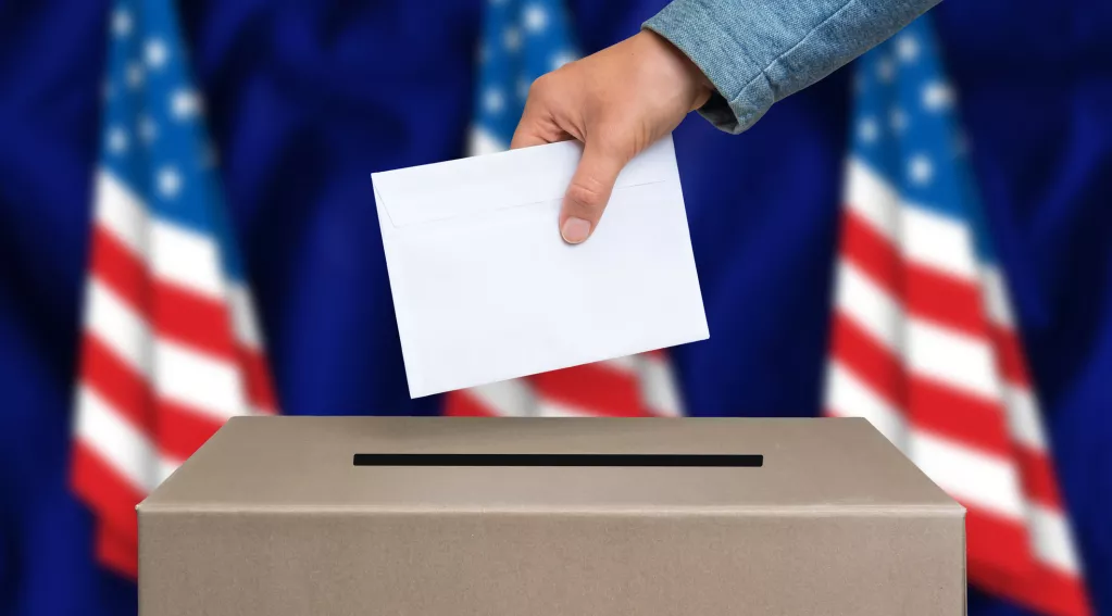 Ballot box in front of 3 small American flags