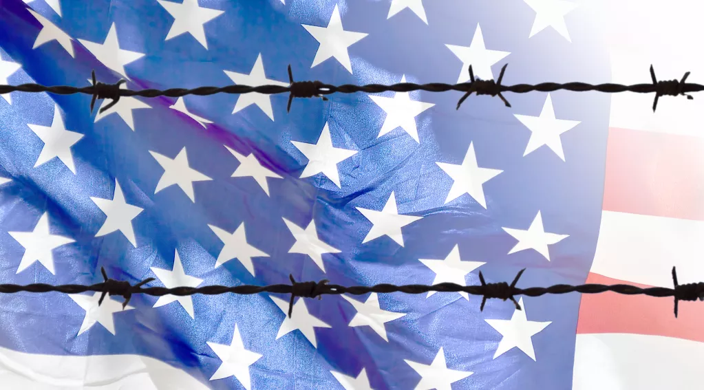U.S. flag behind barbed wires
