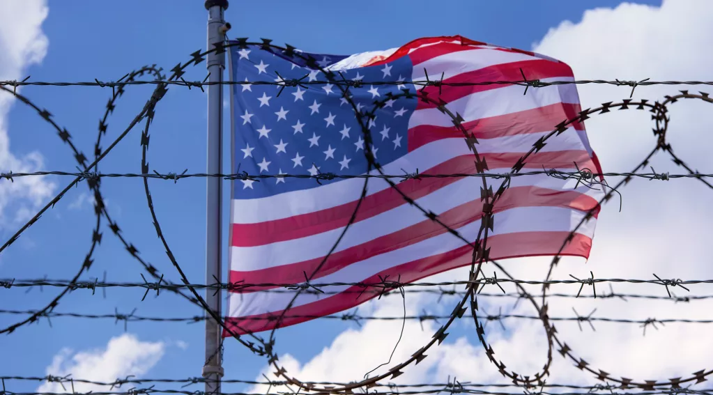 United States flag and border with barbed wire