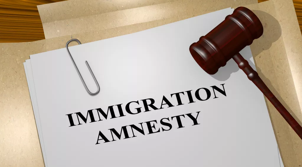 Immigration amnesty written on white paper with court gavel