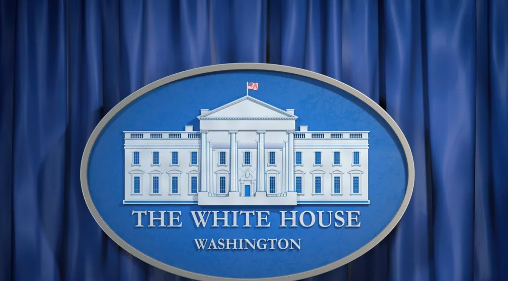 White House emblem with blue curtain backgroiund